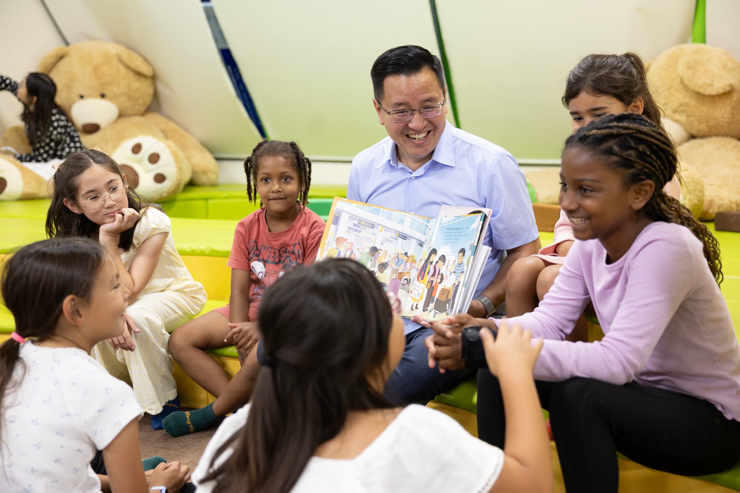 Kent Lee reading with children at a community gathering
